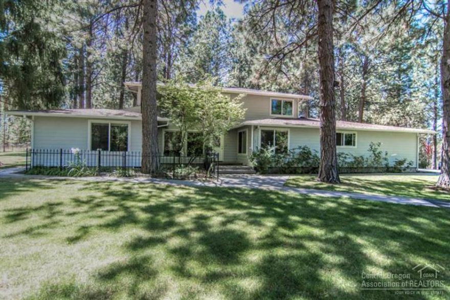 Gorgeous park-like setting on Bend's Westside. This 4 bed + office, 3 bath, 2519 sqft home on 5 acres is sure to please. Interior amenities include a spacious great room floor plan w/ hardwood floors & cozy fireplace. Light & bright kitchen opens to the formal dining room, perfect for entertaining. Plenty of outdoor living space, covered outdoor kitchen & expansive patio. Privacy galore w/ mature landscaping, gardens, fenced, 3 acres of irrigation & large detached shop. Call for your personal tour.