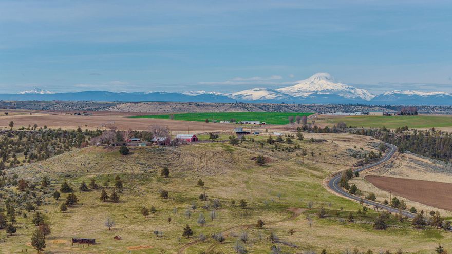 Own 4,544± acres in North Central Oregon with Fessler Hay & Cattle Ranch—a rare blend of productivity, beauty, and legacy investment. The ranch includes 1,204.2± acres of primary irrigation water rights, supporting fertile hay ground and irrigated farmland for high-yield crops and year-round feed. An additional 3,500± acres of rangeland offer excellent grazing and recreation potential. Ideal for cow-calf operations, yearlings, or diversified ag ventures. Fully improved with seven residences, barns, workshops, feedlot, and corrals for turnkey operation. Framed by Cascade Mountain views, this self-sustaining, income-producing ranch unites lifestyle, land, and long-term opportunity.