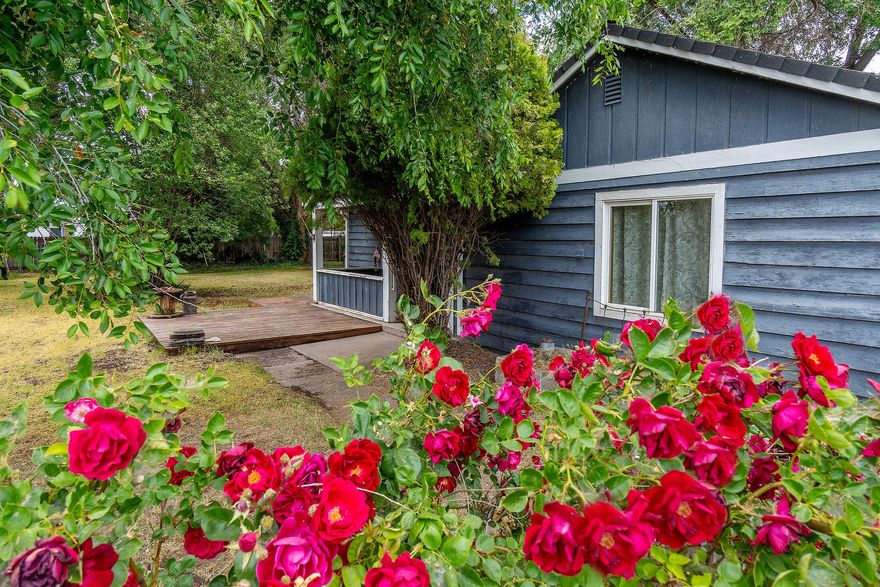 Vintage Single Level Home, Covered Front Porch, Huge Fenced Yard with Big Shade Trees, potential for RV parking or build a shop or ADU. Newer Roof, Windows,
Insulation and sewer plumbing in 2007 and 2008. Very Large Living Room with Stone Wood Burning Fireplace, Dining Area and Roomy Kitchen, Spacious bedrooms and
bathrooms, with office or third bedroom off of the laundry room. Garage was added after home was built. Walking distance to the High School and Fairgrounds. Come Tour Today!