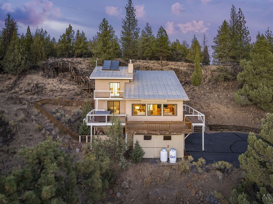 Stunning 2.26-acre retreat minutes from Sisters, Oregon, in the Sisters School District, boasting unobstructed, jaw-dropping views of the Three Sisters Mountains and Broken Top. 

This home features an open layout with so much natural light, expansive windows and huge vaulted ceilings.  New carpet throughout, tile flooring, fresh paint in the bedrooms, updated light fixtures, and an open loft upstairs that would be perfect for an office, reading nook or bonus area. Enjoy the wraparound deck, and Hot Tub for soaking in the serene views and peaceful surroundings. 

The home offers a Paved Driveway, RV Parking, Metal Roof, an attached 2-car garage and a separate 2-car garage with bonus space upstairs - ideal for an office or studio. Quiet, Private, and so much character! A perfect blend of modern updates and natural beauty!