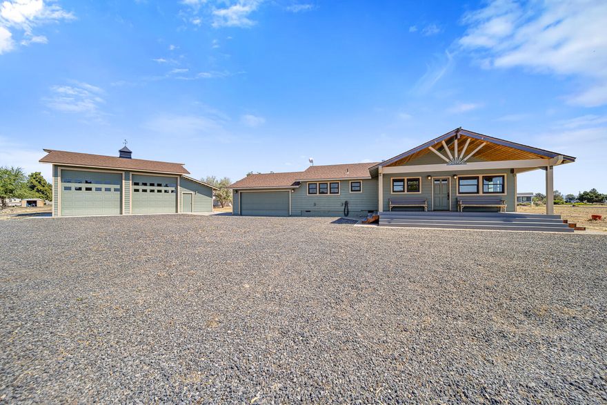 Adorable and full of charm, this unique home is packed with character! From the tongue-and-groove woodwork to the copper countertops, oven hood, and hand-pounded copper walls behind the wood stove, every detail shines. The spacious primary suite boasts vaulted ceilings, French doors to the Trex deck and hot tub, and a spa-like bath with a freestanding tub, walk-in shower, and on-demand hot water for endless comfort. Pendleton curtains add both style and energy efficiency throughout.
The property also features a fully insulated 2-car attached garage plus a large 30.6 x 38.6 insulated shop with 14' roll-up doors—perfect for storing your boat and toys, with Lake Billy Chinook's boat ramp just minutes away. Whether you're seeking a full-time residence or a weekend getaway, this home has it all. CC&R's allow up to 2 horses.