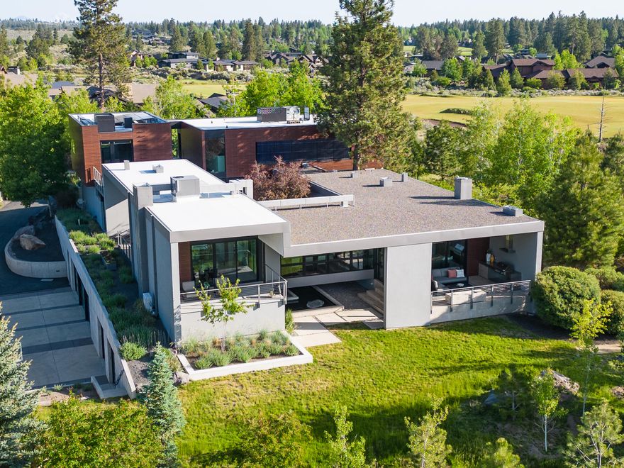 Nestled on a secluded acre deep in the heart of Tetherow, this Eric Meglasson home stands as a masterpiece that embraces the beauty of its surroundings. Every detail of this home's design is a work of art, boasting sleek lines, pristine finishes and an abundance of expansive windows. Whether your gaze rests upon the flagship 17th hole, the majestic Cascades, or the serene zen-like courtyard, the line between indoor and outdoor living is blurred, immersing you in a harmonious connection with nature. Inside, the culinary enthusiast will appreciate the well-appointed kitchen. With four spacious bedrooms, a gym, multiple outdoor living spaces, and a private study, this home offers versatility and privacy for gathering and relaxation. This extraordinary residence is more than a home - it's a sanctuary where contemporary design meets tranquility and functionality.