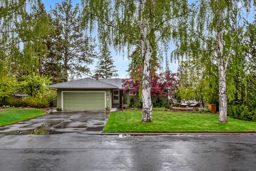 Charming West Hills home just blocks from Newport Ave and minutes to downtown Bend! Enjoy stunning southerly views from the sunny deck, ideal for morning coffee or evening gatherings. This light-filled home features three bedrooms, two bathrooms, and a spacious daylight basement perfect for guests, a media room, or office. Additional highlights include a large laundry room, wine storage room, attached two-car garage plus an extra single-car garage, and a huge workshop, with separate driveway access—ideal for hobbies or storage. Set on a beautifully landscaped lot with great curb appeal, this home blends comfort, space, and location. A rare find in one of Bend's most sought-after neighborhoods.