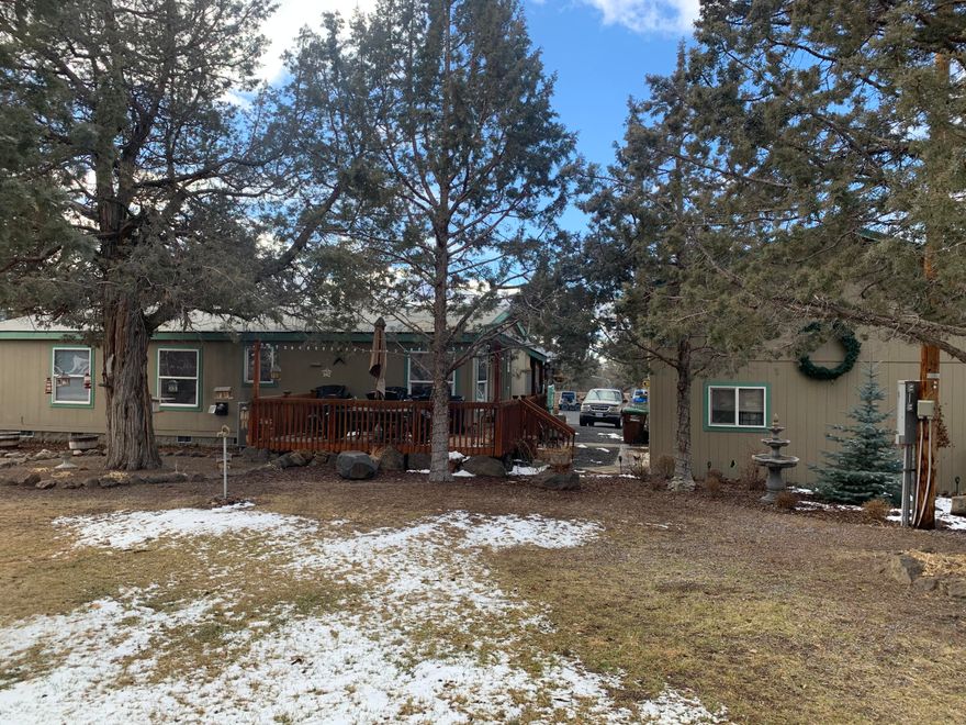 Don't miss out on this exceptionally landscaped and well cared for 3 bed/2 bath home on 1.83 acres. Inside features split floor plan with master separate from 2/3 bedrooms. Deck on front of house to enjoy the landscaping and fully enclosed deck across back of house adds to the living space. 24 x 38 2 car garage with 14' door, insulated shop space, loft storage, plenty of room to work, wall mounted Craftsman cabinets and office area w/ sink/toilet. Second 24 x 34 shop building features room for car/rv/boat storage and room for extras. 2 additional metal carports and separate smaller storage building. Landscaping features deer fencing enclosing over 100 trees (juniper, aspen, evergreens), raised gardens, flower beds and in-ground irrigation systems for all of them. There are 3 fountains and a small pond on the property. This property has so many features and until you see it you really can't appreciate it.