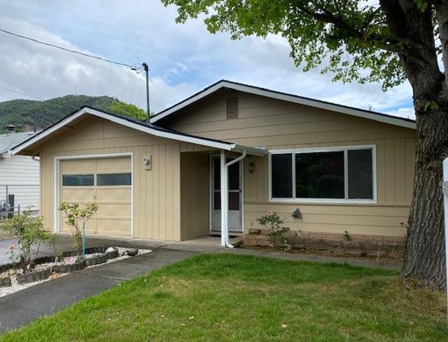 Golden Opportunity! Comfortable 2 bedroom 1 bath home on a rare .29 acre usable lot. Living room with fireplace, kitchen, dining area/family area with glass doors to patio. Two nice size bedrooms and full bath. Enjoy living here, or buy as an investment and explore the potential to build another unit. The 3 bedroom, 2 bath home next door is also available for sale with another .29 acre usable lot for even more options to build additional units, potential to split or ?? Fresh interior paint, carpet, flooring. An attached garage, patio, all city services, city schools, Grants Pass irrigation, great location close to schools and shopping, easy access to I-5, room for garden, RV parking and views of the surrounding mountains!