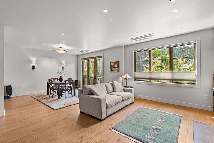 Stylish corner-unit condominium on the second level of Plaza West at First Place in the heart of downtown Ashland. Abundant natural light and airflow with operable wood-wrapped Pella casement windows and French doors, top-down bottom-up cellular shades, solid maple hardwood floors, gas fireplace with limestone surround and built-ins, kitchen with quartz dining bar and counters, tile backsplash, alder wood and glass-fronted cabinets with soft-close drawers and doors, stainless double sink and appliances including five-burner gas range with convection oven, low-profile ceiling-integrated ductless mini-splits, versatile media room or potential guest bedroom, half bath powder room, laundry room, and spacious primary bedroom with full ensuite bathroom, double vanity, jetted tub, shower, and water closet. Gated entrances and elevator access from private garage with dedicated parking and storage. Security system with video surveillance. Certified LEED Platinum. Inquire for details!