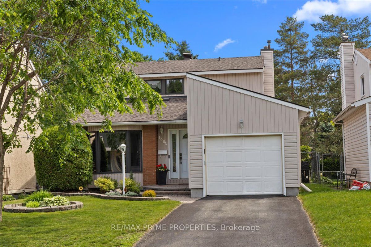 Front of home with single car garage, landscaping