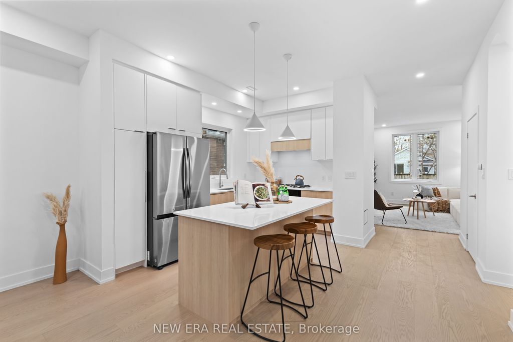 Photo of 148 Rhodes Avenue, Toronto, ON M4L 3A1 (MLS # E12582694)