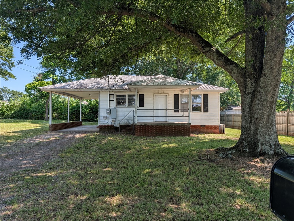This charming home features a practical carport, n