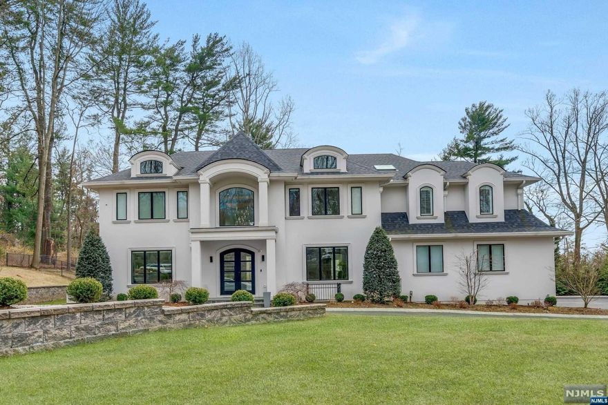 This exquisite two-year young custom home is set on a tranquil private cul-de-sac on the East Hill of Demarest. Set on 1.25 acres with breathtaking sunset views and an oversized custom inground pool with a covered patio and barbeque complete the rear property. The family room is large and bright with a fireplace. Huge custom kitchen and separate eating area with sliding doors leading to the covered patio. There are seven bedrooms and seven and a half baths. All rooms are large and sun-filled. The Master Bedroom suite offers a fireplace and private outdoor patio, two large custom closets and a master bath with a steam shower and free-standing tub. There are six bedrooms in total, four on the second level, one on the main level, The lower level features a movie theater, gym, bedroom, bath, huge entertainment area, and wine cellar. This is truly a masterpiece of design and elegance.