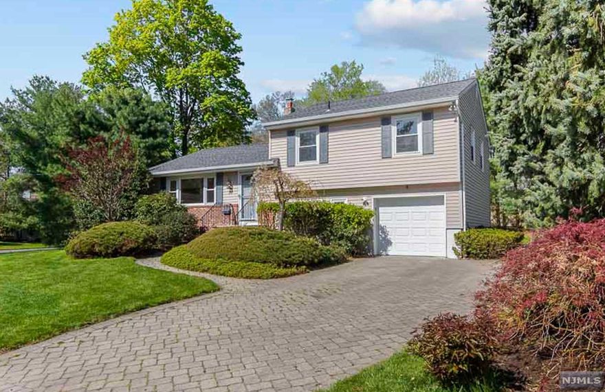 Amazing opportunity to own this newly renovated home in Cresskill, Sun filled living room w/ marble fireplace, dining room off completely renovated kitchen w/ custom cabinets, peninsula w/seating, quartz countertops, new SS appliances, oak floor & new sliders to large deck w/ barbecue for entertaining. Second floor features primary bedroom, new dual bathroom & 2 bedrooms. Large family room & office, new sliders to outside patio, new full bathroom & garage access. Finished basement includes large recreation room, cedar walk-in closet/pantry, Utility room w/ new water heater, boiler, washer & dryer. New roof in 2019 & new garage door. Multi-zone heating, cooling, central vac, sprinkler & much more. Large corner lot on a quiet sun filled street, meticulously landscaped with mature trees & shrubs offers privacy & enjoyment of the back yard. Close to NYC transportation & GWB Bridge. Must see! The VIRTUAL TOUR link has a comprehensive video tour, & interactive 3D model.
