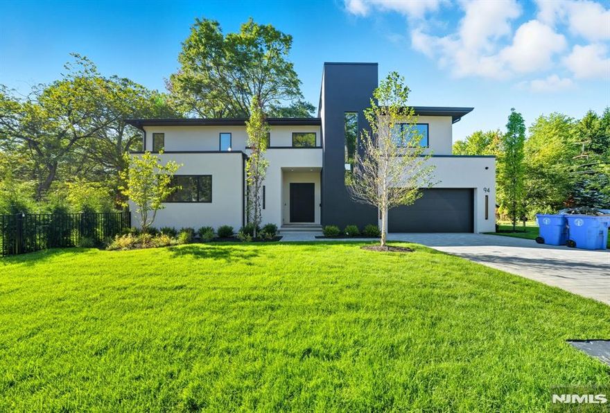 Experience modern luxury in this exquisite new home featuring soaring 10-ft ceilings, oversized Pella windows, and an open floor plan designed for elegance and comfort. A double-entry foyer flows into the dining and family room with fireplace, seamlessly connecting to an enclosed patio and fully fenced, manicured grounds with lush trees. The Italian chefâ€™s kitchen boasts custom cabinetry, walk-in pantry, and premium finishes. A guest suite, full bath, mudroom, and 2-car garage complete the main level. Upstairs, the lavish primary suite includes a spa-like bath and expansive closets, accompanied by 3 additional ensuite bedrooms and laundry. The 9-ft lower level offers a legal bedroom, full bath, theater, lounge, recreation space, and abundant storage. Ideally located near houses of worship, top schools, downtown, and NYC transit.