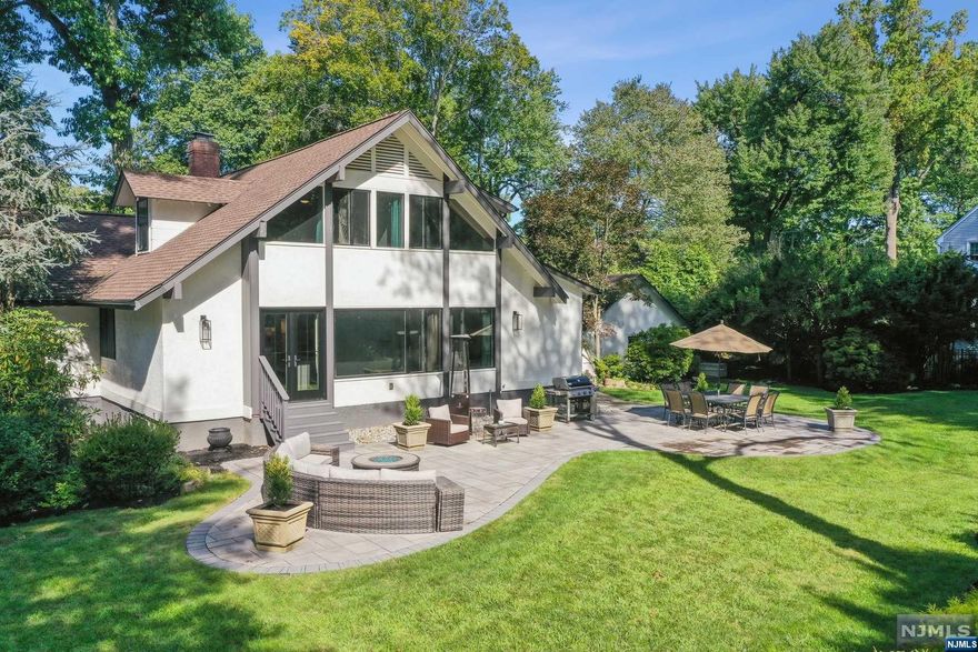 Step into this extraordinary home, completely transformed inside and out and situated on an expansive corner lot in Oradell's highly coveted Latchstring section. This peaceful retreat is framed by meticulously landscaped grounds, offering a serene oasis perfect for relaxation and unforgettable entertaining. Behind its charming exterior, you'll discover nearly 3,000 square feet of exquisitely renovated living space, plus a finished walkout basement that adds even more versatility. The interior features a spacious living room and a chef-inspired kitchen, showcasing dual dishwashers, a white oak center island, a copper sink and luxurious finishes throughout. Of the five generously sized bedrooms, the primary suite truly shines as a private retreat, offering a spa-like bathroom with a soaking tub, separate shower and ample space to unwind. Adding to the allure of this exceptional property is its prime location, offering close proximity to Oradell's top-rated schools, train & downtown.