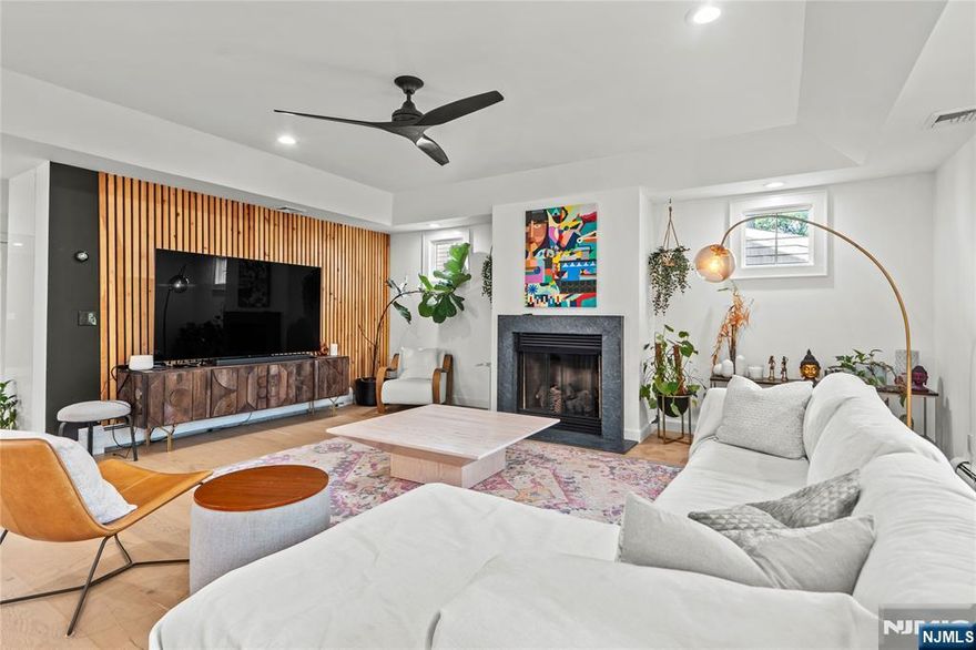 Prepare to be wowed by this stunning 6-bedroom residence in Rutherford, perfectly situated to blend modern luxury with a resort-style retreat. This home has been transformed with a completely renovated first floor that exudes sophistication. Step inside to find beautiful new hardwood floors sweeping through the open-concept living space. The centerpiece is a chefâ€™s kitchen featuring custom cabinetry and top-of-the-line stainless steel appliances, including a professional Wolf stove and oven. Gather in the living area around the beautiful fireplace, framed by a striking custom accent wall, or refresh in the stylishly updated powder room. The luxury extends to the upper levels, offering six spacious bedrooms, including a primary suite with a steam shower and Jacuzzi tub. The finished basement adds incredible value with a home theater and surround sound for movie nights. Outside, your private oasis awaits. The backyard is an entertainer's dream, featuring a heated in-ground pool, patio, and bar area designed for summer enjoyment. Located just minutes from the Rutherford train station and bus lines to NYC, this home offers the perfect balance of suburban tranquility and commuter convenience.