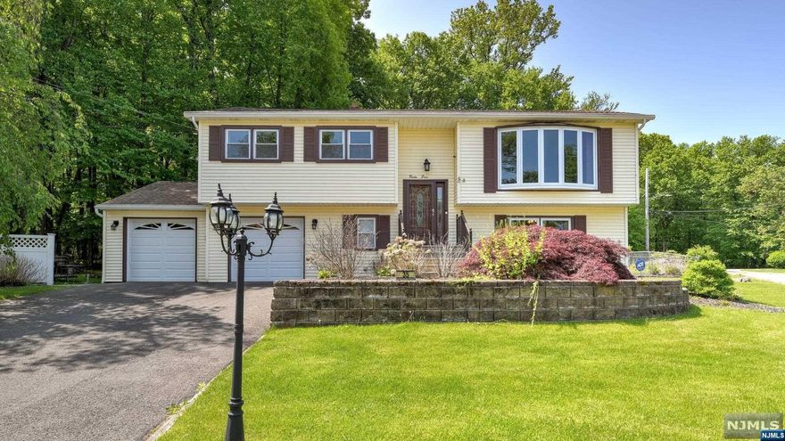 Hidden gem nestled in quiet established neighborhood in Butler, this home features modern upgrades throughout! Inviting & well-maintained home with attach 2-car garage set on large tranquil .46-acre level corner lot. Main level features bright & open LR, DR, updated Kit, 3 BR's w/HW floors & updated full bath (2022). Sliding glass doors in DR lead to expansive 2-level Trex Deck - the perfect place to entertain or relax & enjoy a view of the woods! On Low Lev, which offers potential in-law suite, is the Primary Bedroom, updated full Bath w/jet tub, FR w/gas FP, Lndry & Util Rooms. FR sliding doors lead to paver Patio where you can enjoy outdoor living! Fenced Yard w/mature landsc. Rec updates incl Furnace (2021), H/W Htr (2021), Garage Doors/Openers (2022), updated Kit (2008,2022), Gen Transfer Switch. Incl Ring Doorbell, 3 Blink Cameras, Cen Air, Nat Gas, Pub Wtr & Sewer! Incl 1 Yr Home Warranty! Easy access to major hwys, approx 33 mi from NYC. Come see this warm & inviting home!