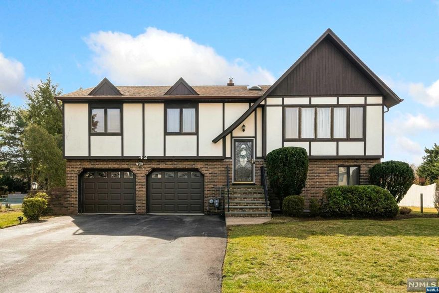 Welcome to this stunning Tudor style bi-level home located on one of the best streets in desirable Lincoln Park! This meticulously maintained property boasts 3 bedrooms, 3 full bathrooms, and plenty of space for extended living. As you step inside, you are greeted by an airy foyer w/ skylight that floods the space with natural light. The main level features the LR w/ vaulted ceiling, gleaming refinished hardwood floors and large windows that allow plenty of natural light to filter in. The open-concept floor plan flows seamlessly into the dining room & kitchen, complete with SS appliances, granite counters, and breakfast bar. Glass sliders to large low maintenance Trex deck w/gas plumbed from house for BBQ that overlooks the serene huge backyard. Also on the main level is the primary bedroom w/ ensuite bath, 2 additional bedrooms and another full hallway bath. The lower level has 2 dens (can be home office, gym, or 4th bedroom) gas fireplace, full bathroom, utility&laundry room.