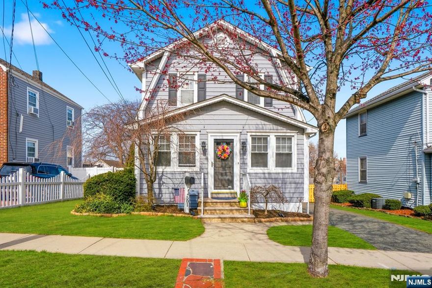 This charming sidehall colonial style home showcases 3 bedrooms/ 2 baths and is surrounded by a canopy of flourishing trees making this home a tranquil enclave. Newer kitchen with ample counter space, stainless steel appliances, & breakfast bar! Filled with an abundance of natural light, this home offers a warm and inviting ambiance and effortless flow throughout with easy access to the yard and a two tiered deck. All three bedrooms are on the second level. Finished bonus room, full bath and laundry in basement. The outdoor space is ideal for gatherings beautifully enhanced by a graceful Japanese maple tree, a blooming peach tree, and a fragrant Southern Magnolia tree creating a relaxing setting. Truly a harmonious, lovingly cared-for home! Easy commute to nyc; close to schools, dining, and shopping too! Don't miss this one!
