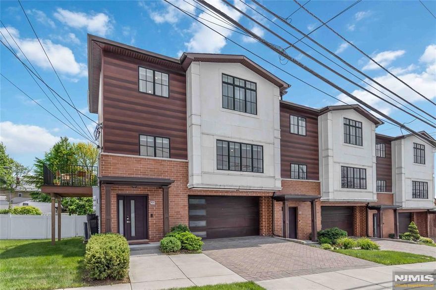 This beautifully maintained 3-bedroom, 2.5-bath corner townhome offers the perfect blend of modern design and everyday comfort. Built just six years ago, the home features 9-foot ceilings, crown molding, and an open-concept layout ideal for todayâ€™s lifestyle. The bright and spacious kitchen is the heart of the home, showcasing quartz countertops, stainless steel appliances, abundant cabinetry, and a generous center island overlooking the living and dining areas. A gas fireplace adds warmth and character to the inviting living space. A convenient powder room complete the main level. Upstairs, the primary suite offers a private retreat with a well-appointed en-suite bath featuring tasteflly selelcted tile in a clean contemporary feel. Two additional bedrooms and a full bath provide comfortable space for family, guests, or a home office. Enjoy the added benefit of a corner location with your own yard and a low-maintenance composite deckâ€”perfect for relaxing or entertaining. Additional highlights include central air, beautiful hardwood floors throughout and a 2-car garage. Ideally situated near restaurants, shopping, and NYC transportation, this home offers both convenience and a sought-after location. Move right in and enjoy modern townhome living at its best!