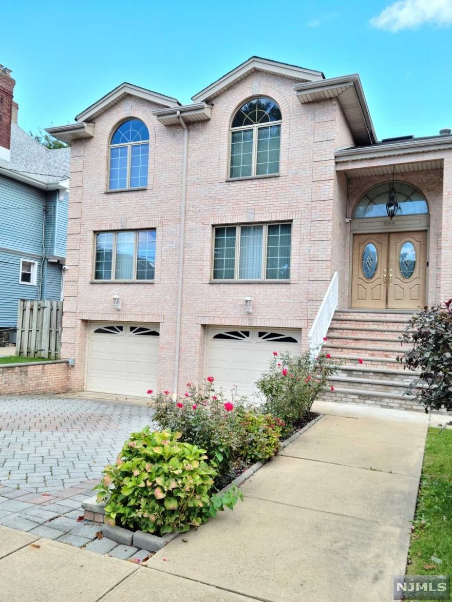 Welcome to this Lovely Brick exterior colonial house in great Location,WHY? Rent when you can own your own luxury home. NYC bus stop steps away and easy access to all the major Highway,There Are numerous of amenity,smart light control by Phone,intercom,Home security camera,projector TV,Custom-made blinds,Fire Place,Jacuzzi, Hardwood Floors throughout house with full expose to sunlight,First Floor layout with Living Room, Dining Room ,gorgeous kitchen with granite counter tops and stainless steel Appliances ,cozy family Room comes with projector and fireplace,Coat Closet, Nice deck and Huge Back yard ,2nd floor comes with 4 Bedroom 2 Full bathroom ,Master bedroom with Jacuzzi,Beautiful Crystal chandelier on the Stairs ,Separate Entrance to ground level comes with extra family room and Bedroom,full Bathroom,update kitchen.2 car Garage,Central AC ,Central Vacuum system ,Don"t miss the opportunity!! READY TO MOVE IN !! Seller Holds NJ Real Estate License