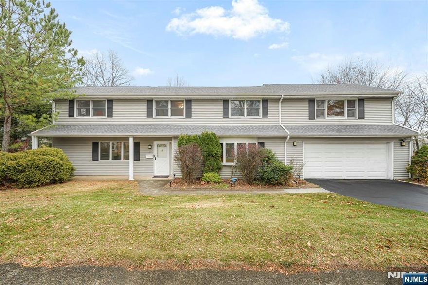 Welcome to 12 Clinton Lane--over 2700 sq ft and a basement! The ground level welcomes you with a lovely foyer, a huge family room, and a flexible office, den, or guest room with a nearby powder room and abundant closet space. This level offers great everyday living and work-from-home options. The main living level features open-concept space with a renovated kitchen offering a breakfast bar, dining area, prep island, and generous granite countertop space. Sliders lead to a large deck, creating additional room for entertaining or enjoying sunset and mountain views.The second floor offers four bedrooms and three full baths, including a newer primary suite with two walk-in closets and a spacious bath. The original primary suite includes its own bathroom, dual closets, and hardwood floors beneath the carpet, as shown in the AI renderings. The remaining bedrooms and hallway also have hardwood floors under the carpet and share a large full bath. The walk-out basement provides laundry, French drains, storage, and future finishing potential. Recent updates include a 3-year-old roof, 2025 furnace & condenser for the main home, 2023 hot water heater, and 200-amp service. Ideally located near Blue Ribbon Fallon Elementary School, adjacent to Wayne Valley High School, close to the Wayne Public Library, Whole Foods, shopping, dining, parks, community programs, and convenient NYC transportation.