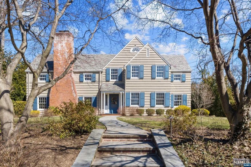 Simply stunning. Modern center hall colonial in the heart of Ridgewood's architecturally significant Old Country Club section. Picture perfect inside and out with a triple mint top-to-bottom renovation and an entertainer's dream backyard featuring a gunite pool & spa and an expansive patio with a fireplace & wood-burning pizza oven. Energized open concept with nautical palettes and natural light throughout, from the living room with fireplace & French doors to a study featuring a chic wet bar, to the pristine modern eat-in kitchen with top-of-the-line appliances, center island, and designer backsplash. Formal dining room, breakfast room, great room, mudroom and powder room wrap up the 1st floor. Relax in luxury in the primary suite with vaulted ceilings and a spa-like bath. Four more bedrooms on the 2nd level, including 2 ensuites with beautifully updated full baths. Spacious finished basement, 2-car garage, excellent school district, and premier location. A true Ridgewood gem!