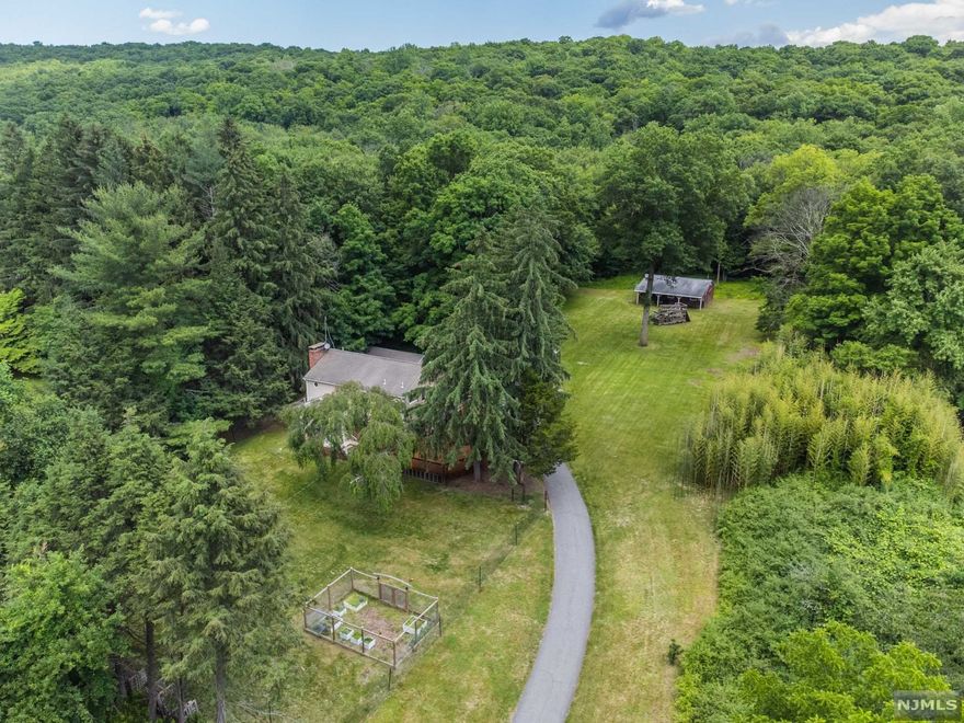 Nature Lovers Retreat!! Welcome to this fabulous open concept Contemporary home on 3 acres with 2 car detached garage and separate barn (for potential horses) backing to reservoir property with direct access to hiking trails. The main floor is impressively open and fabulous for entertaining with no walls and a stunning custom steel staircase at the center point of the home. Features include 3 BRs, 2.1 BA, beautiful wood flooring with radiant heat, a cozy and comfortable pellet stove, French doors to expansive deck, multiple split unit AC's, full walkout lower level with wood burning stove and much more! The 2nd floor boasts a spa like master suite with soaking tub, walk in shower, walk in closet and 2 BR's with shared full bath. Ideal for entertaining inside and out! Possibility for expansion with NEW 4 BR Septic. Close to Monksville Reservoir, Ringwood Manor and Minutes to NYC express bus.