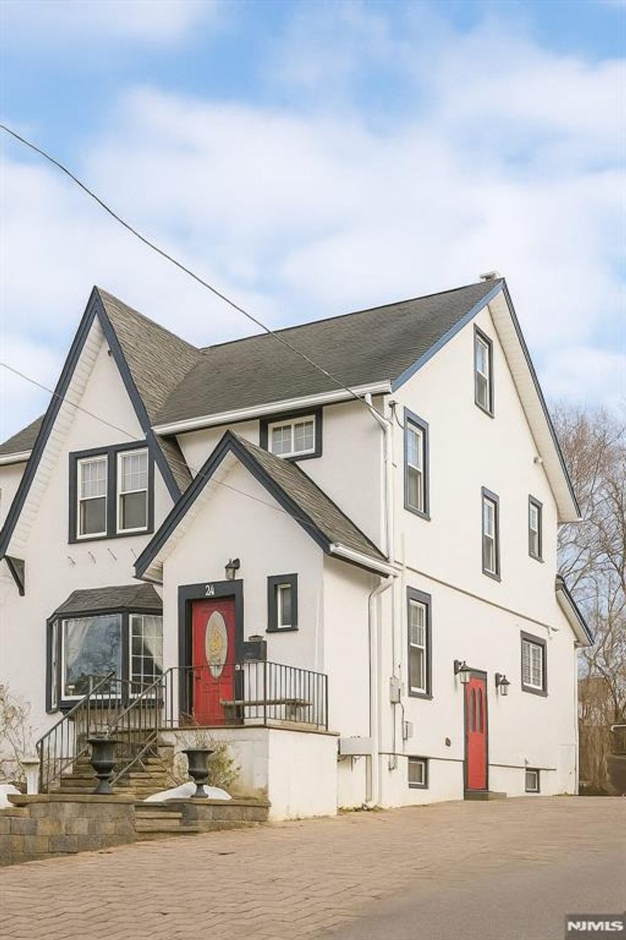 Colonial Style Home offering a classic design with symmetrical facade and traditional features like the 9 ft. ceilings, a mix of oak and pine wood throughout, ipe wood deck built on a concrete slab, high quality windows, 2 car garage plus parking for over 5 cars, 5 year old boiler, sprinkler system, water softener etc. This is a strong home that seats on the border of million-dollar properties while inviting you to enjoy a vibrant town filled with history. This home is located half a block from bus stop to NYC, just minutes away from train station and mall..