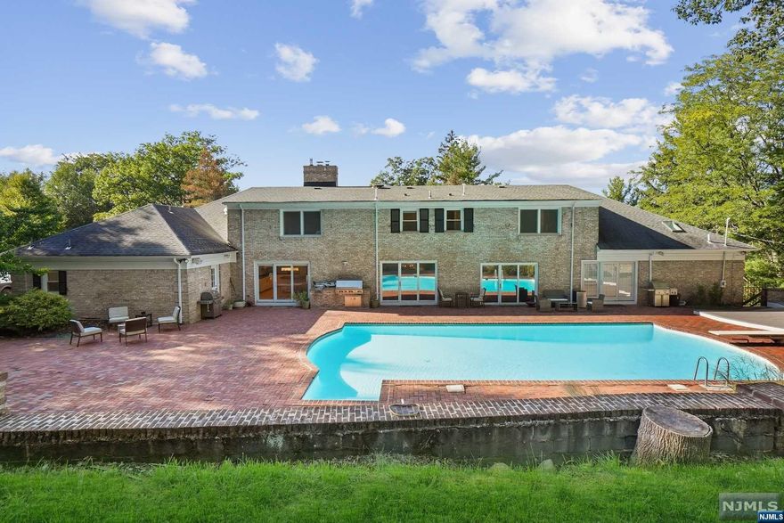 Short Hills show stopper located in sought after Deerfield Elementary section with 8000+ sq ft! Fully renovated 7/8 Bedroom, 6.1 Bath custom home on acre of private, lush property. Multiple levels of living and entertaining including resort-like heated pool. Foyer and grand curved staircase opens to Living Room with glass doors to patio; Dining Room; Library / Great Room and Powder Room. Eat-In Kitchen with granite countertops, high-end appliances, center island + built-in workspace. Laundry Area + Mudroom with access to 4-car garage + Bedroom next to a full Bath. 1st Floor Primary Wing features 2 en-suite bedrooms. Primary Suite includes walk-in closet/dressing room and spa-like Bath + direct pool access. Addl en suite bedroom. 2nd level with 3 large Bedrooms + optional Primary Suite. Lower Level- Rec Room with Wet Bar, cooktop, microwave + Gym,Sauna, Wine Cellar, 2nd Home Office, Studio/ bedroom with closet and egress window, Bonus Room with a closet, storage rooms + Full Bath.