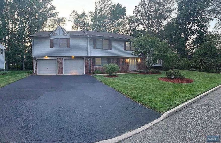 Affluent N. Cliffs Spacious Home. Very Rare Two Master bedrooms for extended family, absolutely gorgeous large home East Facing with upgraded finishing - hardwood flooring throughout home, video doorbell, recessed lighting throughout, granite and marble bathrooms, crown molding, tankless water heater, oversized Lot, Garage and Driveway... there are to many upgrades to list. Master bedroom has a California style closet. Extremely well maintained, Large deck & attached storage space in the backyard with a huge pool sized backyard. 3 miles to GW Bridge and a stones throw to the New LG Headquarters. This home is like living in an Oasis with several Oak Trees, it's like being in a retreat but yet just a few minutes away from NYC. Close to public transportation, shopping, restaurants, and state parks... New Furnace, Condenser and Boiler Heater. You will enjoy upscale living in this home. Priced for Quick Sale, Best Priced home in North Englewood Cliffs! Also available for rent at $7500