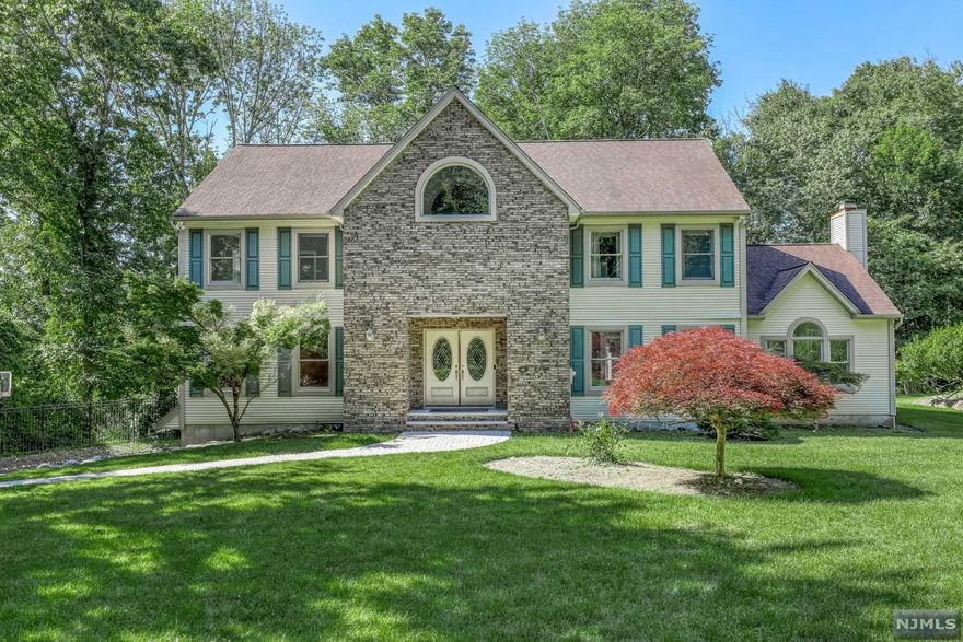 Quality built center hall colonial on a wooded & secluded .9 acre lot nestled on a cul-de-sac. This 5-BR, 3-bath home has a stunning custom designed chef's kitchen w top-of-the-line Thermador appliances, shaker-style cabinetry, & Nero Marble Marquina countertop. Kitchen: center island, built-in banquette dining, bar cabinetry, walk-in pantry, & sliders to Trex deck. Lovely views & walk-out access from great rm w vaulted ceiling & gas fireplace. 2-story Calacatta marble floored entry foyer leads to the large living rm & dining rm w Brazilian cherrywood floors & designer chandeliers. 1st flr BR & updated full bath is conducive to multi-generational living. 2nd flr: a large primary BR suite w huge WI closet & bath w dual sink vanity, stall shower, & whirlpool tub. 3 addtl BRs, full bath, & large laundry rm complete the 2nd flr. Walk-out basement is full & finished w a kitchenette, room to add full bath, & rec rm. 3-car gar, central vac, multi-zone HVAC, sprinkler, and security.