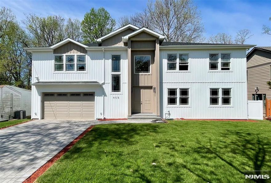 Welcome to this exceptional newly built residence offering approximately 4,600 sq ft of elegant living space plus a finished walk-out lower level. This thoughtfully designed home features 5 bedrooms and 4.5 baths with a dramatic 20-ft ceiling in the living room, red oak hardwood flooring, and expansive windows filling the home with natural light. The chefâ€™s kitchen showcases a stunning waterfall quartz island, premium appliances, and seamless flow ideal for entertaining. The private primary suite includes a walk-in closet and spa-inspired bath. The finished walk-out lower level with 9.5-ft ceilings provides flexible space for recreation, guests, or a home office. Exterior highlights include modern vertical siding with Azek trim, Andersen windows, a striking 96-inch entry door, paver driveway, full irrigation system, and fully fenced yard. An oversized garage with 11-ft ceilings and dual-zone HVAC completes this impressive offering. A rare opportunity to own sophisticated new construction in one of Bergen Countyâ€™s most desirable communities.