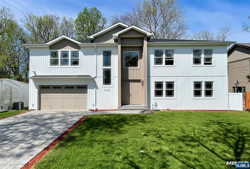 Welcome to this exceptional newly built residence offering approximately 4,600 sq ft of elegant living space plus a finished walk-out lower level. This thoughtfully designed home features 5 bedrooms and 5.5 baths with a dramatic 20-ft ceiling in the living room, red oak hardwood flooring, and expansive windows filling the home with natural light. The chefâ€™s kitchen showcases a stunning waterfall quartz island, premium appliances, and seamless flow ideal for entertaining. The private primary suite includes a walk-in closet and spa-inspired bath. The finished walk-out lower level with 9.5-ft ceilings provides flexible space for recreation, guests, or a home office. Exterior highlights include modern vertical siding with Azek trim, Andersen windows, a striking 96-inch entry door, paver driveway, full irrigation system, and fully fenced yard. An oversized garage with 11-ft ceilings and dual-zone HVAC completes this impressive offering. A rare opportunity to own sophisticated new construction in one of Bergen Countyâ€™s most desirable communities.