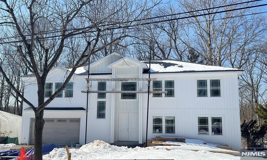 Welcome to this exceptional newly built residence offering approximately 4,600 sq ft of elegant living space plus a finished walk-out lower level. This thoughtfully designed home features 5 bedrooms and 4.5 baths with a dramatic 20-ft ceiling in the living room, red oak hardwood flooring, and expansive windows filling the home with natural light. The chefâ€™s kitchen showcases a stunning waterfall quartz island, premium appliances, and seamless flow ideal for entertaining. The private primary suite includes a walk-in closet and spa-inspired bath. The finished walk-out lower level with 9.5-ft ceilings provides flexible space for recreation, guests, or a home office. Exterior highlights include modern vertical siding with Azek trim, Andersen windows, a striking 96-inch entry door, paver driveway, full irrigation system, and fully fenced yard. An oversized garage with 11-ft ceilings and dual-zone HVAC completes this impressive offering. A rare opportunity to own sophisticated new construction in one of Bergen Countyâ€™s most desirable communities.