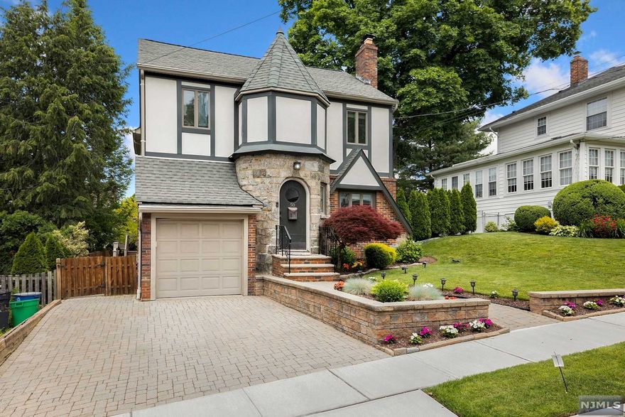 Need more space? Look no further! The present owners have done a wonderful renovation and expansion on this Tudor style home in highly desirable Yantacaw prime location just steps to Nutley Park. This home's many features include an open concept, hardwood flrs throughout, living room - wood burning fireplace with gorgeous stone front & mantle. Formal dining room with custom built-in bar with wine fridge. Family room complete with custom cabinetry and stunning gas FP & glass door leading out to deck with steps to paver patio and wood fenced yard. Renovated kitchen, Custom wood cabinets, center island w. prep sink, granite counters, SS appliances & pantry. Spacious primary ensuite w/ walk-in closet, oversized steam shower, double sinks. second floor 3 additional bedrooms , full bath & laundry. Exterior- Hardie Plank, professionally landscaped, 3 Zone Sprinkler System, 2 Zone AC, 4 Zone heating.