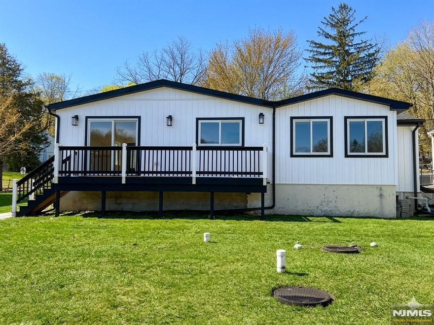 Welcome to this fully renovated lakefront gem in the desirable Mount Glen Lakes section of West Milford. Set on an oversized, level 0.40-acre lot with direct lake frontage and year-round water views, this 3-bedroom, 2-bath ranch offers the perfect blend of modern design and effortless one-level living. Completely redesigned in 2025, every detail has been thoughtfully updated for todayâ€™s lifestyle. Step inside to a bright, open living/dining area with beautiful wood floors and abundant natural light. Sliders off the living room lead to a deck overlooking the lake â€” the perfect place to relax or entertain while enjoying peaceful waterfront scenery in every season. The stunning new kitchen features sleek cabinetry, stylish countertops, and stainless steel appliances, including a gas range. One bedroom features its own private full bath, while two additional bedrooms share a second beautifully renovated bath. A convenient main-floor laundry closet is located in the hallway for easy access. The lower level offers excellent storage space and houses the utilities. With central air, natural gas heat, a blacktop driveway, lake privileges, and turnkey condition throughout, this is true one-level lake living at its finest.