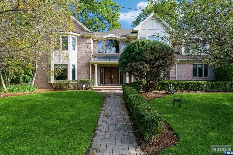 Welcome to this elegant 2004 6-bedroom East Hill home, boasting an open, light-filled atrium and a family room with a vaulted ceiling and fireplace. Enjoy a gourmet kitchen with cherry cabinets and Viking appliances. Features include hardwood floors, architectural moldings, and a primary bath with radiant heat floors. The efficient 8-zone heating and a fully finished basement with an extra bedroom and bath add to its appeal. Outside, an inviting patio and yard await. Conveniently located near schools, town center, and NYC transport, this home is a must-see for those seeking style and comfort.