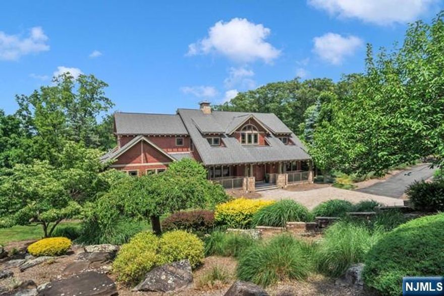 Nestled at the end of a tranquil cul-de-sac on nearly 3 acres in Valhalla Ridge, this stunning Craftsman-style home offers over 6,000 sq. ft. of luxurious living space, plus a fully finished basement. Upon entering, you're welcomed by an open floor plan with vaulted ceilings, custom trim, and abundant natural light. The gourmet kitchen boasts top-of-the-line appliances, ample cabinetry, and a waterfall island perfect for meals and entertaining. The first-floor primary bedroom is a private oasis with two walk-in closets, a dressing room, and an en-suite bath with a jetted tub and steam shower. Four spacious upstairs bedrooms provide comfort and privacy. The finished basement shines with a second kitchen, full bath, multiple rooms, and a private entrance ideal for an in-law suite or entertainment space. Enjoy serene outdoor living on the deck and patio, perfect for alfresco dining or unwinding in your private retreat.