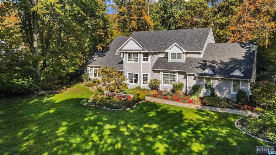 Nestled on the coveted & scenic Corrigan Way, this exquisite farmhouse col. beckons. Main level has a 2 story entry foyer, an expansive living room & a sophisticated home office featuring elegant French doors & built-in shelving. The modern eat-in kitchen seamlessly unfolds into the grand family room, showcasing a striking stone wall fireplace. Glass doors open to a vast deck, providing a panoramic view of the expansive backyard. 1st floor boasts an en-suite with new full bath. Discover the lavish primary bedroom, complete w/ a private entrance, dual closets & tranquil en-suite bathroom feat. dual vanity & jacuzzi tub. 3 generously sized bedrooms & a full bathroom. Finished basement offers a haven of entertainment, movie theatre, full bathroom, a spacious rec. room, a bedroom, and a versatile gym/office space. Backyard oasis, feat. a gunite heated pool & a European-inspired al fresco dining area. This property epitomizes the perfect blend of modern amenities & charm.