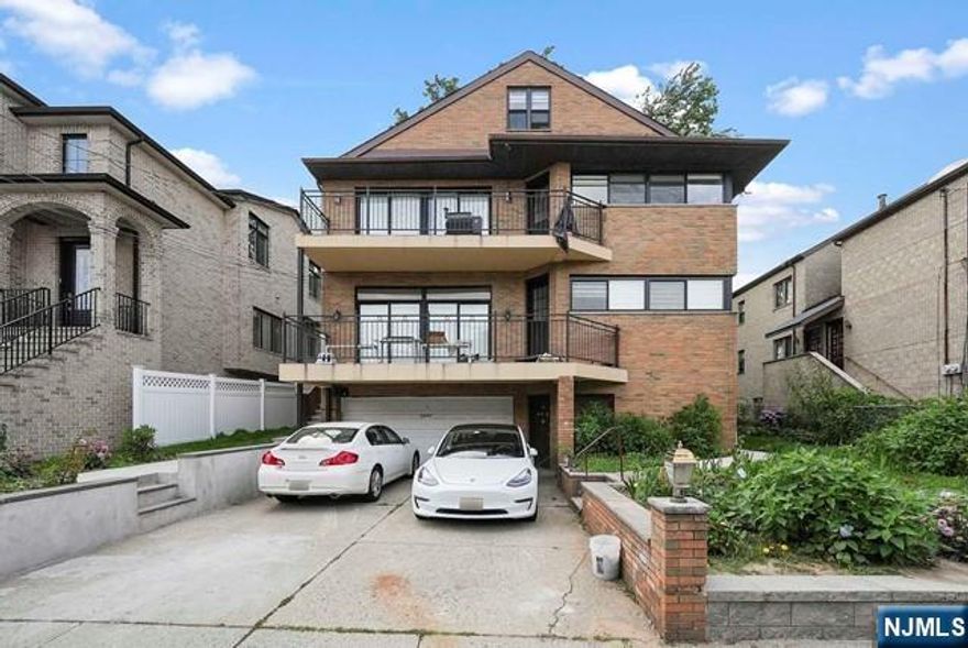 Unique spacious loft style living in Fort Lee NJ, 2 minutes from the GWB! Unit has 4 beds 2 full baths, newly renovated with washer and dryer in unit. Kitchen features a wraparound window for plenty of sunlight including dual access to the large patio space. Loft style high volume ceilings in the living room area, with a spiral staircase to the additional spacious room and office workspace on the top level. Main level features the primary bedroom with an en-suite bath + walk-in closet and 2 additional bedrooms and sleek bathroom. Rent includes 1 garage + 1 driveway parking spots.