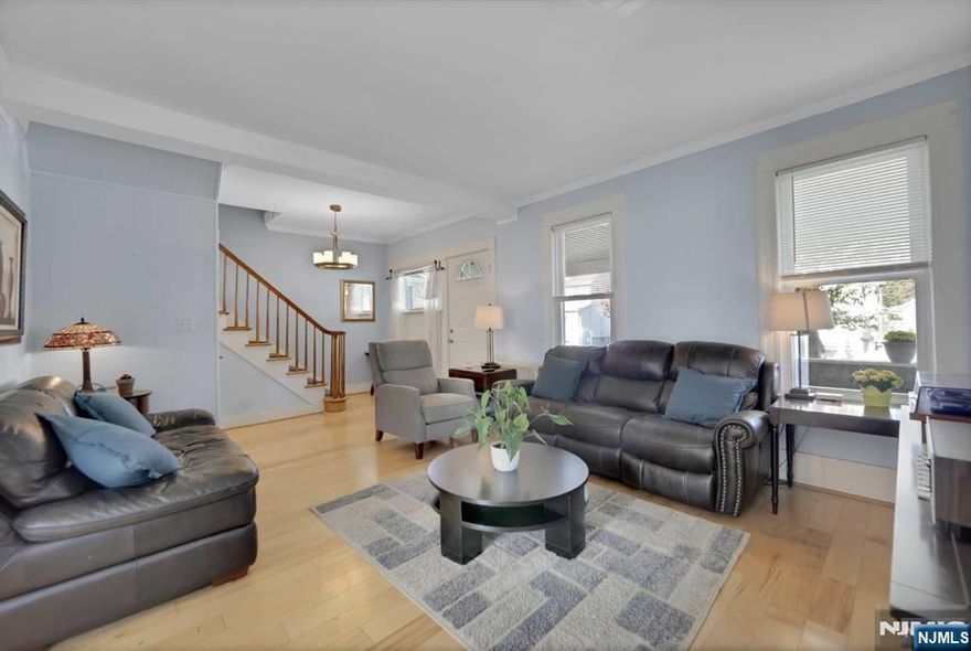 Move right into this spacious, well-maintained side hall colonial with numerous upgrades! A charming covered front porch welcomes you inside, where the formal living room features crown molding, and the full-size dining room offers a perfect space for gatherings. The renovated kitchen includes granite countertops, a tile backsplash, and access to the backyard. Upstairs, you'll find three bedrooms and a beautifully updated main bathroom. The finished lower level adds extra living space with a recreation room, half bathroom, and laundry room. A large walk-up attic offers great storage or potential for additional living space. This home boasts a brand-new roof with new plywood and gutters, engineered wood floors, a newer hot water heater, high ceilings, and mostly replaced windows. Enjoy the professionally landscaped yard with a paver patio. A long driveway leads to a two-car detached garage for convenient parking. This home is a must-see!