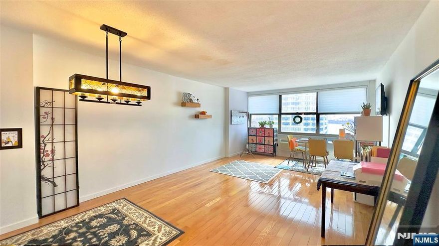 Enjoy spectacular views of the Hudson River and New York City skyline from on the 25th Floor. Resort-style amenities including indoor and outdoor pools, a fitness center with weight room, sauna, tennis courts, library, 24-hour concierge, and on-site conveniences such as a deli, spa, pharmacy, and dry cleaner. Building Amenities Live like you're on vacation year-round with world-class facilities right at your doorstep: Wellness & Fitness: State-of-the-art weight room, full cardio gym, and a relaxing on-site spa. Seamless access to NYC via ferry or bus. NJ Transit buses and private jitneys stop directly at the doorstep.