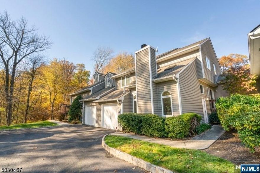 This highly sought-after "St. Andrews" model townhome is ideally situated on a tranquil cul-de-sac, Backs into a wooded lot and just a short stroll to the community pool and clubhouse. The inviting foyer opens to a dramatic family room with vaulted ceilings, skylights, and wood burning fireplace, creating a bright and welcoming space. The expansive floor plan includes a large living room with deck access, offering picturesque yard views and flows seamlessly into the dining room with a skylight. The eat-in kitchen boasts white cabinets, stainless steel appliances, ample storage, and a second deck perfect for BBQs and outdoor entertaining. Generously sized rooms and abundant closets provide excellent storage throughout. The primary suite features three closets, including a walk-in, and a luxurious ensuite with a jetted tub, double vanity, and separate shower. A finished basement expands the living space with recreation and entertainment areas, a 4th bedroom, another home office option, and a convenient laundry room. Nestled in The Highlands in this beautifully landscaped community. This home offers serene living with versatile living including multiple home office options. As one of the largest and most desirable models, it's also a commuter's dream with easy access to NYC. Don't miss this exceptional opportunity! new tax assessment/ Taxes have been reduced from $16,455 to 13,481