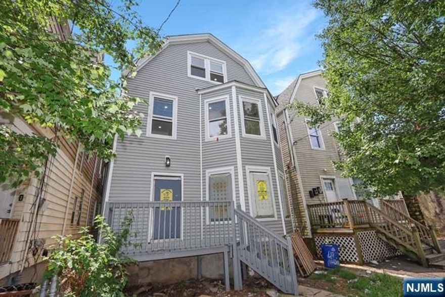 Ladies and gentlemen, let me take you on a journey through a property that's more than just a house it's a statement. Nestled in Newark stands a magnificent three-unit home that is the epitome of modern luxury and timeless elegance. This is not just any property; it is a turn-key opportunity for savvy investors or homeowners who are looking to make a smart move and offset their mortgage while living in style. Each of the three spacious units offers three bedrooms, providing ample room for owners or tenants to enjoy. The real showstoppers here are the two units that feature master suites each designed with a touch of class that makes every day feel like a retreat. We're talking about beautifully designed kitchens and baths that showcase quality finishes and thoughtful design. Now, imagine stepping into a home where every inch has been meticulously updated to better-than-new condition. The layouts are bright and airy, with high ceilings that create an expansive feel.