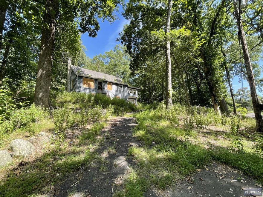 Nearly 2 acres in Wayne Township, at the end of a cul-de-sac! Lots of privacy and NOT in flood. Create your own private retreat just 30 Minutes from NYC. Existing home has 4BR's, plus a bonus sun room over garage, and a full basement. Buyer responsible for all inspections, tests, and any required township inspections for obtaining a C/O to close. Public sewer and water connections are available at curb. Property will require all cash to close, or rehab loan if attempting traditional financing. Sold strictly AS-IS.