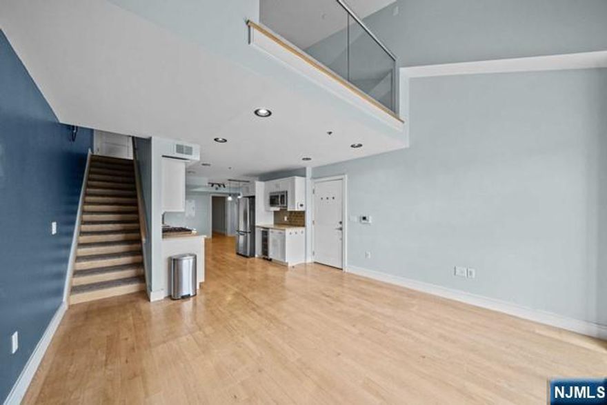 Modern Duplex-style condo with 2-bedroom, 2-bathroom, plus a spacious loft space, within seconds of the Hudson River Walkway in a prime commuter location. Open floor plan, floor-to-ceiling windows, hardwood floors, ample closet space, washer/dryer in-unit, and a parking spot in the indoor garage. On the 1st floor is a living room with a 2-story window, a kitchen with stainless steel appliances, a wine fridge, and all-white cabinetry that flows into the designated dining area, a full bath, and a bedroom with a terrace & 2 large closets. Upstairs is a loft space that is perfect as a second living room & features a skylight, washer/dryer, and a sizable primary suite with a trendy sliding barn door walk-in closet and a full bath. Truly a commuter's dream location! Only 15 minutes from NYC with an NYC bus at your doorstep. Close to shopping, excellent and parks. Pets allowed. Tenant is responsible for all utilities except water. Unpack and move right in!