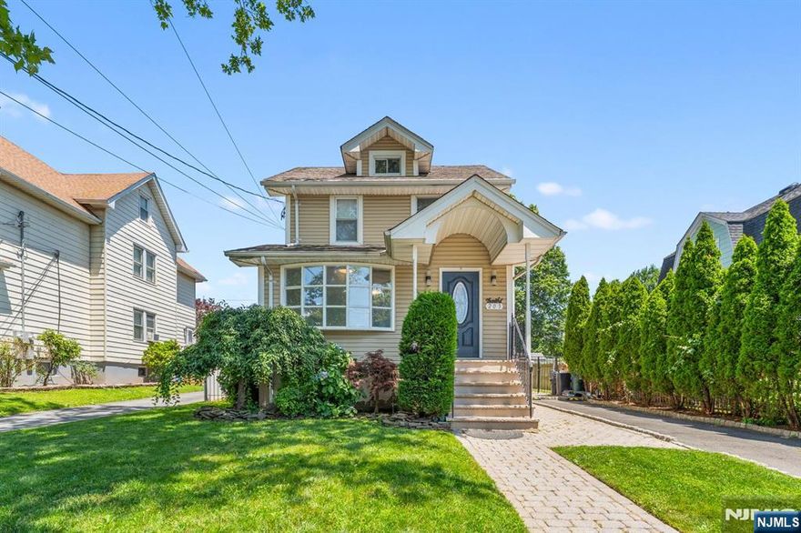 Welcome to this beautifully maintained and deceptively spacious Colonial, offering over 3,100 square feet of living space across four fully usable levels. With 5 bedrooms and 3.5 baths, this home combines charm, functionality, and modern updates throughout including gleaming hardwood floors and recessed lighting. The main level features a large formal living room, an updated kitchen with center island, a dining room, a home office area, a convenient half bath, and a generously sized family room perfect for gatherings. Upstairs, you'll find four bedrooms and two full baths, including a massive primary suite. The finished basement adds even more versatility with a full bath, while the walk-up attic provides incredible potential for future use or storage. Enjoy off-street parking, central air, and a fully fenced backyard with brick paver patio, ideal for outdoor entertaining. Located just a short walk to NYC transportation, this is a rare opportunity you wonâ€™t want to miss!