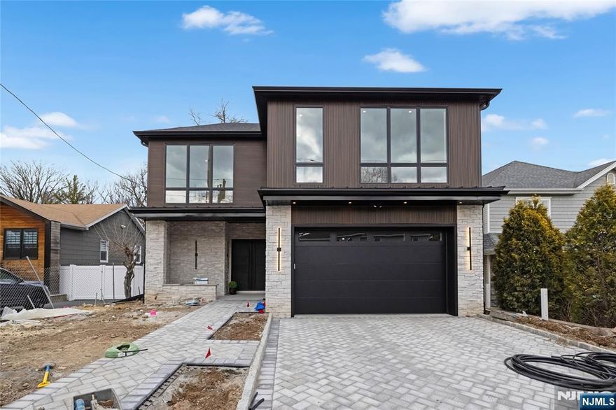 Brand New Construction in Englewood Cliffs built by RockSolid Builders! Layout and Design is Spectacular! Over 6,500 sqft. 11ft ceilings on the main level! 9ft ceilings in basement and 2nd fl. Chef's Kitchen w. custom built cabinetry, SUB-ZERO & WOLF Appliances. Waterfall Island & large Butler's Pantry. Large Great Room leading to outdoor patio with Pergola.. Bedroom/Office w/ Full Bath on 1st level plus powder room, LR, DR. 2nd level features a Primary Suite with a Galley and large Custom Walk in Closets . Spa-Like Primary Bathroom w. soaking tub, toilet closet, double vanities, glass shower. Each of the 3 additional bedrooms have en-suite bathrooms and generous closet space. Large finished basement with additional den and media room with home theater included & full bathroom. Generator included! 2 car garage leading into a mudroom. COMPLETED. A must see! Home is Staged!