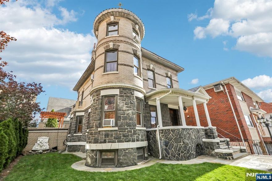 Proudly perched on the corner of Broadway and 78th Street, just one block from beautiful Braddock Park, this stately two-family home blends timeless elegance with modern comfort. Behind the nostalgic front gates, an inviting porch with original speakeasy doors sets the tone. Inside, youâ€™ll find exquisite chestnut woodwork, gold leaf crown moldings, 10-foot ceilings, and a showstopping staircase, all hallmarks of classic craftsmanship. The sun-filled parlor and formal dining room, framed by pocket doors and adorned with chandeliers and medallions, create the perfect setting for entertaining. Upstairs offers three spacious bedrooms, a custom dressing room, and a marble bathroom. The top floor is a private retreatâ€”featuring soaring beamed ceilings, hardwood floors, skylights, a spa-inspired bath, a wet bar, and a rare vaulted turret with skyline views. The lower-level unit has its own entrance, full kitchen, bedroom, den, and bathâ€”ideal for guests, extended family, or rental income. Outdoor living shines with a two-car garage, new bluestone patio, lush landscaping, and an upper-level pergolaâ€”perfect for relaxing or enjoying sunset views. Just two blocks from the NYC bus and minutes to the NY Waterway Ferry, this lovingly maintained Victorian is a rare opportunity to own a true classic.