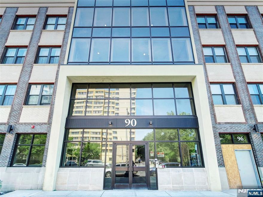 Welcome to this beautifully maintained 2 bedroom, 2 full bath condo at the Lofts at Lincoln Park, offering the perfect blend of space, style and unbeatable convenience in Newark's vibrant Arts District. Featuring hardwood floors throughout, the open-concept living and dining area is ideal for both everyday living and entertaining. The updated kitchen is equipped with granite countertops, stainless steel appliances, ample cabinetry and a breakfast bar perfect for casual dining or hosting guests. The spacious primary suite offers a walk-in closet with custom shelving and a private en-suite bath with double vanity, while the second bedroom and full bath provide flexibility for guests or home office. Additional highlights include in-unit laundry, central/forced hot air and an assigned garage parking space...a rare and valuable perk in downtown Newark. Residents enjoy access to an onsite fitness center and private courtyard, all just moments from Newark Penn Station with direct access to NYC access, as well as dining, entertainment and cultural destinations. Schedule your showing today and experience everything this condo has to offer.