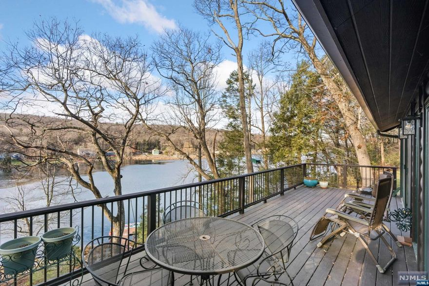 Lakefront move-in ready home on 1 acre in Stokes State Forest on Kittatinny Lake. Lake view from all rooms through the wall to wall sliding glass doors that open to a 32X10 deck on both levels. The main floor open concept is approx 800SF creates effortless entertaining indoors and out plus a full bathroom. Totally updated with radiant heat flooring, central air conditioning and a cook's kitchen. The bedroom level measures approx 600SF with each bedroom en-suite. The loft, approx 177SF, perfect for an office or guest room. Storage room is 11'X 7'. All appliances, incl W/D, stay. Parking that can fit 5 cars and a path that meanders through the private backyard to the lake. Lake life at its finest with your own dock perfect to canoe and kayak from as well as to sit back and soak in the evening sky. Hike the Appalachian Trail in your own backyard. Furniture and boats negotiable. Seize this rare opportunity to kick off your summer fun!